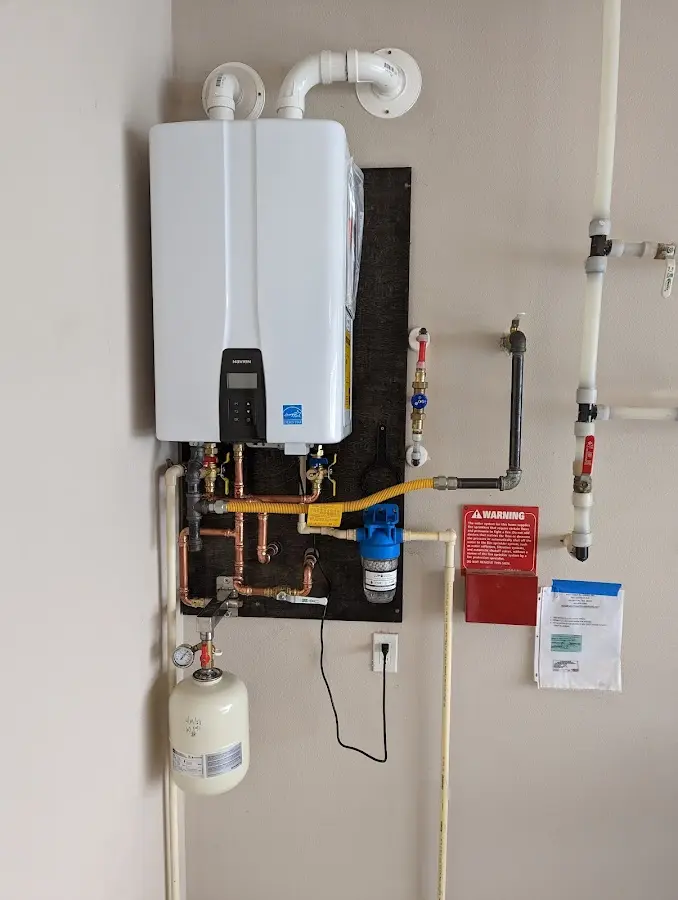 Professional plumber installing copper piping in a Avalon home